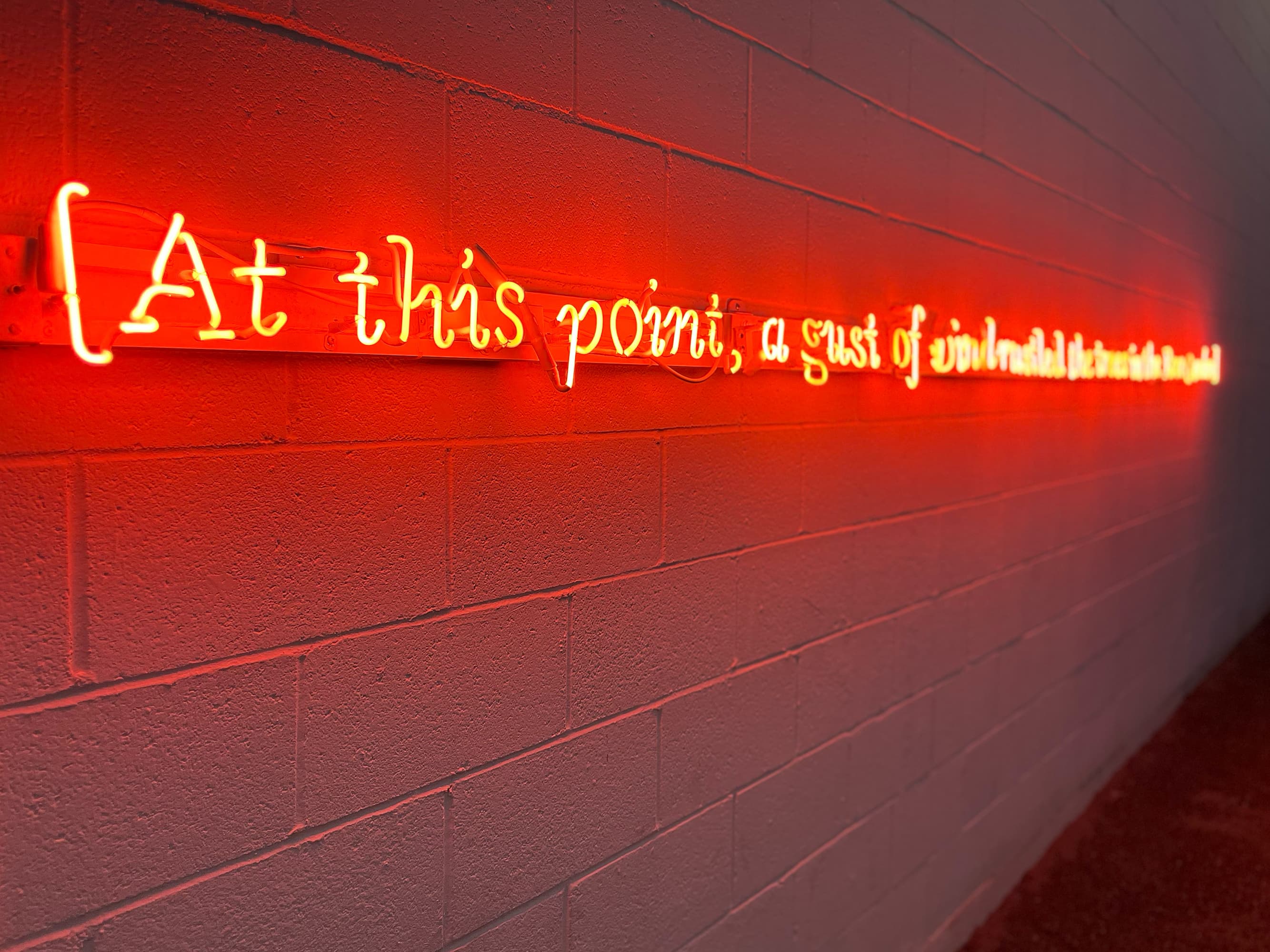 Stenographer's Note: [At this point, a gust of wind rustled the trees in the Rose Garden.], 2025, neon, transformers, wire, approximately 15 feet wide