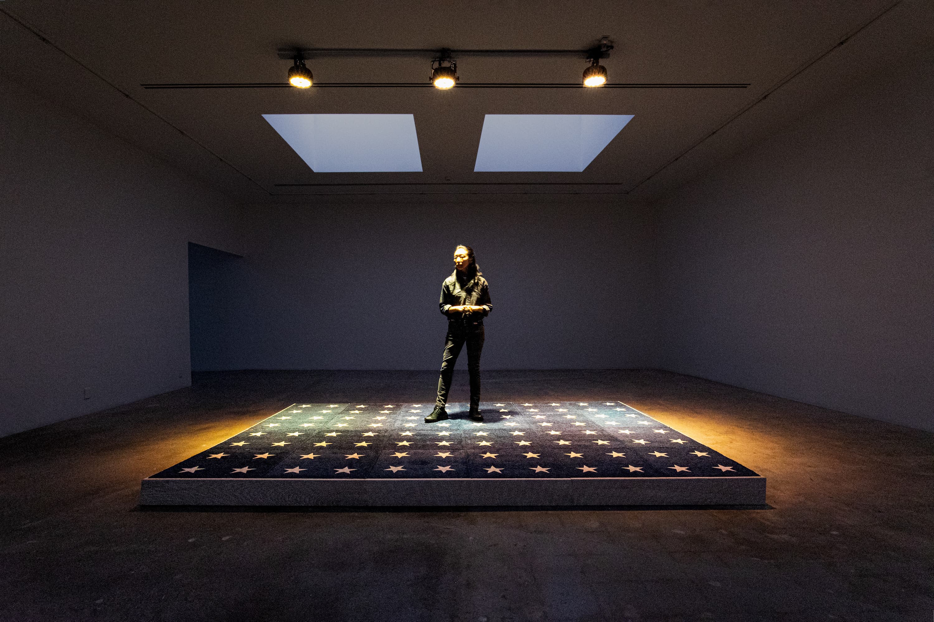 Esther Kim Varet on The Platform (U.S. General Elections, 2026), 2025, raised wooden platform with dye sublimated carpet, documents, 6.25” x 145” x 97”