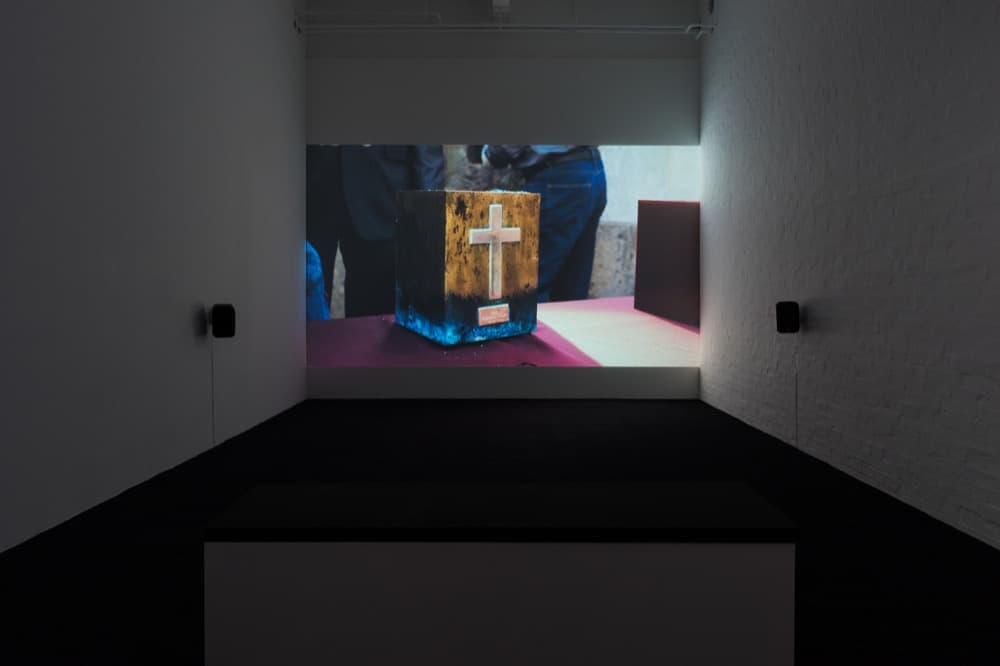 Installation view of The Exhumation, 2016 . HD video,  6’7"