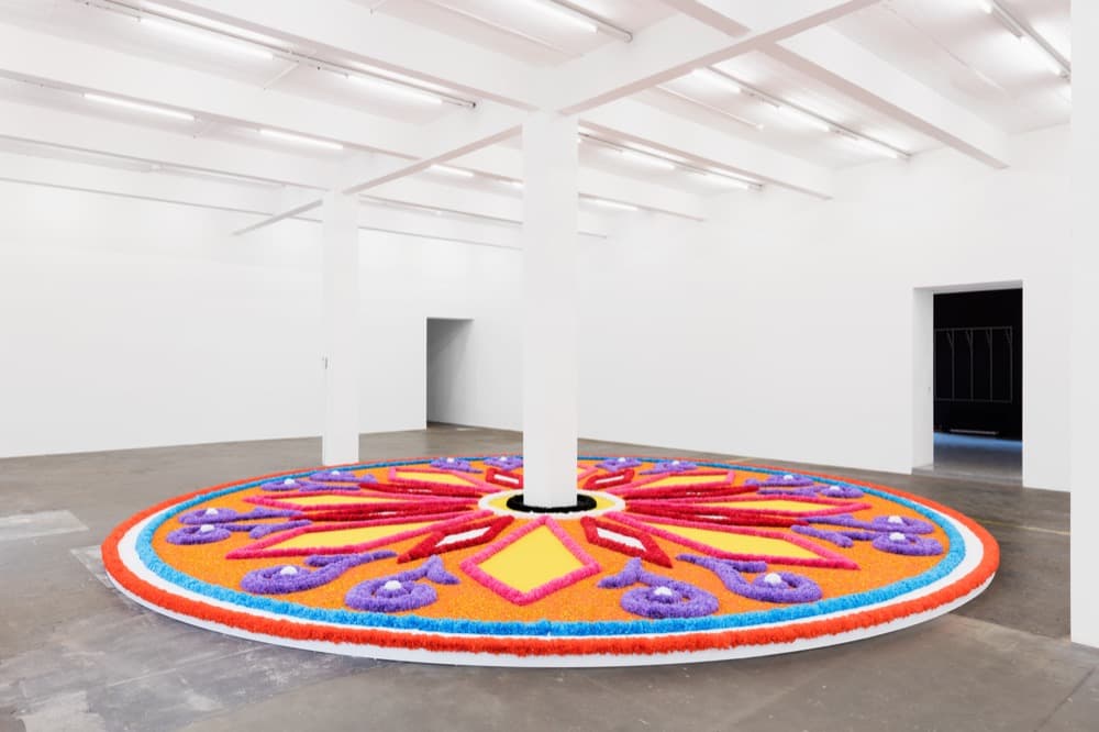 The Offering (Tapete de Flores), 2016 . Artificial flowers, natural flowers, dyed sawdust, salt, glue . 8 meters in diameter.