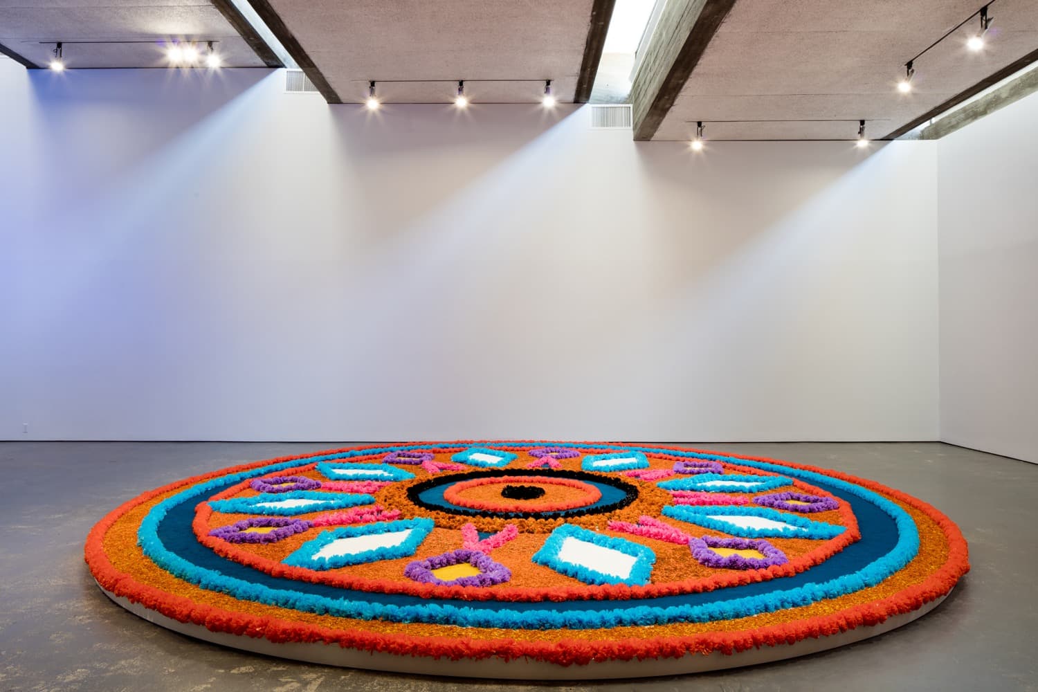The Offering (Tapete de Flores), 2016
. Artificial flowers, natural flowers, dyed sawdust, salt, glue
. 8 meters in diameter.